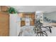 Bright kitchen with wood cabinets, white appliances, and a breakfast bar with seating overlooking the living room at 158 Palisade Loop # 158, Pawleys Island, SC 29585