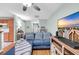 Open living room with a plush blue sofa, ceiling fan, and large TV at 158 Palisade Loop # 158, Pawleys Island, SC 29585