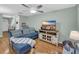 Cozy living room features a plush blue sofa, ceiling fan, and entertainment center at 158 Palisade Loop # 158, Pawleys Island, SC 29585