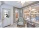 Cozy sunroom with tiled floor, ceiling fan, comfortable wicker chair, and lots of windows at 158 Palisade Loop # 158, Pawleys Island, SC 29585