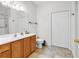 Bright bathroom with wood vanity, white tile, and walk-in shower at 160 Lazy Willow Ln. # 202, Myrtle Beach, SC 29588
