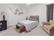 Relaxing bedroom with neutral colors, plush seating, and custom artwork at 160 Lazy Willow Ln. # 202, Myrtle Beach, SC 29588