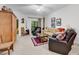 Spacious living room featuring plush seating, and sliding doors to a serene outdoor view, with a wooden accent cabinet at 160 Lazy Willow Ln. # 202, Myrtle Beach, SC 29588