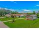 Aerial view of a lovely brick home with a metal roof and large green space in established neighborhood at 175 Cypress Ln., Little River, SC 29566