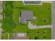 Aerial view showcases the house with a large lawn, surrounding trees, and a peaceful setting at 175 Cypress Ln., Little River, SC 29566