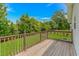 Spacious back deck overlooks a large, grassy backyard with mature trees at 175 Cypress Ln., Little River, SC 29566