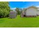 Grassy backyard with a storage shed and deck, perfect for outdoor living at 175 Cypress Ln., Little River, SC 29566