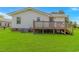 Backyard view of the home's deck, AC unit, and grassy lawn at 175 Cypress Ln., Little River, SC 29566