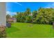 Expansive backyard featuring lush greenery, a storage shed, deck, and AC unit at 175 Cypress Ln., Little River, SC 29566