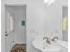 Bright bathroom with a pedestal sink, large mirror and beach-themed decor at 175 Cypress Ln., Little River, SC 29566