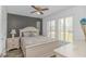 Inviting bedroom with a gray accent wall, window shutters, and natural light at 175 Cypress Ln., Little River, SC 29566