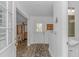 Inviting home foyer featuring wood-look floors, a front door, and sightlines into other rooms at 175 Cypress Ln., Little River, SC 29566