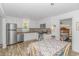 Well-lit kitchen with stainless steel appliances, white cabinets, and dinette set at 175 Cypress Ln., Little River, SC 29566