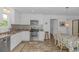 Well-lit kitchen with stainless steel appliances, white cabinets, and dinette set at 175 Cypress Ln., Little River, SC 29566