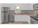 Bright kitchen featuring stainless steel appliances, white cabinetry, and modern countertops at 175 Cypress Ln., Little River, SC 29566