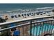 View from balcony of the ocean, beach, and a pool with lounge chairs at 201 S Ocean Blvd. # 408, Myrtle Beach, SC 29577