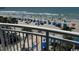 Balcony overlooking the beach, pool, and ocean with blue umbrellas at 201 S Ocean Blvd. # 408, Myrtle Beach, SC 29577