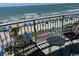 Balcony with chairs overlooking the ocean, beach, and a pool at 201 S Ocean Blvd. # 408, Myrtle Beach, SC 29577