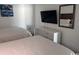 Bedroom with two beds, white dresser, flat screen tv and a decorative mirror at 201 S Ocean Blvd. # 408, Myrtle Beach, SC 29577