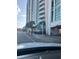 View from a car of a condo building with palm trees lining the street and signs reading Vacancy 1-2-3 bedrooms at 201 S Ocean Blvd. # 408, Myrtle Beach, SC 29577