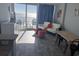 Cozy living room with ocean views, balcony access, neutral sofa, television, and table at 201 S Ocean Blvd. # 408, Myrtle Beach, SC 29577