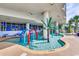 Outdoor water park area with small pool, water features, and palm tree accents, offering fun for all ages at 201 S Ocean Blvd. # 408, Myrtle Beach, SC 29577