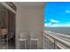 Oceanfront balcony view, with two white chairs, overlooking sandy beach and pier at 201 S Ocean Blvd. # 616, Myrtle Beach, SC 29577