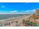 Beautiful beach view with ocean, umbrellas, and sandy shoreline at 201 S Ocean Blvd. # 616, Myrtle Beach, SC 29577