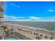 Scenic view of the beach with lounge chairs, umbrellas, and ocean pier at 201 S Ocean Blvd. # 616, Myrtle Beach, SC 29577