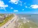 Scenic aerial view of the beach with colorful umbrellas, a pier, and oceanfront condos at 201 S Ocean Blvd. # 616, Myrtle Beach, SC 29577