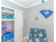 Bright bedroom with coastal decor, closet, and comfortable armchair at 201 S Ocean Blvd. # 616, Myrtle Beach, SC 29577