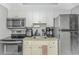 Efficient kitchen design with white cabinets, stainless steel appliances, and ample counter space at 201 S Ocean Blvd. # 616, Myrtle Beach, SC 29577