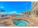 Community pool featuring a hot tub, palm trees, and plenty of lounge chairs at 201 S Ocean Blvd. # 616, Myrtle Beach, SC 29577