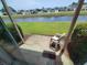 Back porch offering a relaxing outdoor space overlooking a serene canal at 207 Double Eagle Dr. # E-1, Surfside Beach, SC 29575