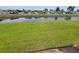 Expansive backyard with a tranquil pond view, surrounded by lush green grass and neighborhood homes at 207 Double Eagle Dr. # E-1, Surfside Beach, SC 29575