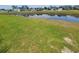 Scenic backyard view featuring a serene pond and lush green lawn at 207 Double Eagle Dr. # E-1, Surfside Beach, SC 29575