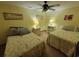 Bedroom featuring two beds, ceiling fan, carpet flooring, and bedside tables at 207 Double Eagle Dr. # E-1, Surfside Beach, SC 29575
