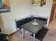 A cozy dining area features a sleek black table and cushioned benches, illuminated by a stylish pendant light at 207 Double Eagle Dr. # E-1, Surfside Beach, SC 29575