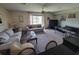 Spacious living room with neutral tones and stylish decor, featuring a ceiling fan and view to a beautiful lake at 207 Double Eagle Dr. # E-1, Surfside Beach, SC 29575