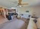 Bright living room featuring a comfortable white sofa and a rattan coffee table, with the kitchen visible in the background at 207 Double Eagle Dr. # E-1, Surfside Beach, SC 29575