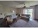 Bright living room with neutral sofas and coffee table overlooking a tranquil outdoor view at 207 Double Eagle Dr. # E-1, Surfside Beach, SC 29575