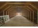 Unfinished attic featuring wood frame and flooring with a doorway at the far end at 2135 Starduster Ln., Little River, SC 29566