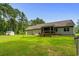 Expansive backyard with lush lawn, screen porch, a shed, and mature trees offering shade and privacy at 2135 Starduster Ln., Little River, SC 29566