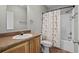 Cozy bathroom featuring a vanity, toilet, and shower with a floral curtain at 2135 Starduster Ln., Little River, SC 29566