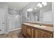 Bathroom featuring double sinks, a large mirror, and a shower with glass doors at 2135 Starduster Ln., Little River, SC 29566