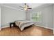A serene bedroom featuring a ceiling fan, wood flooring, and a window with natural light at 2135 Starduster Ln., Little River, SC 29566