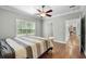 Cozy bedroom featuring a window, ceiling fan, and neutral walls, creating a relaxing atmosphere at 2135 Starduster Ln., Little River, SC 29566