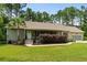 A charming home with a covered porch, lush landscaping, and a well-maintained lawn at 2135 Starduster Ln., Little River, SC 29566