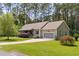 A lovely single-Gathering home features an attached garage, lush lawn, and manicured landscaping at 2135 Starduster Ln., Little River, SC 29566