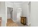 Hallway view with an eye-catching console table leading to a bedroom with a ceiling fan at 2135 Starduster Ln., Little River, SC 29566